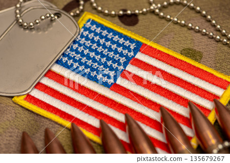 Close up of combat cartridges placed on embroidered United States flag. Close up of combat cartridges placed on embroidered United States flag. 135679267