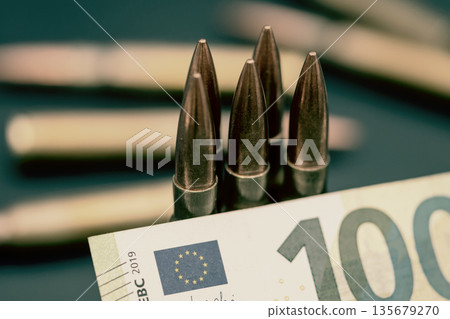 Ammunition placed on euro banknote with European Union symbolism. Ammunition placed on euro banknote with European Union symbolism. 135679270