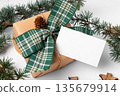 Christmas rectangle gift tag mockup with present box on white wooden background Christmas rectangle gift tag mockup with present box on white wooden background 135679914