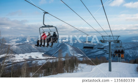 Ski Lift Chairs Move Over Snowy Landscape During Winter Day in Mountain Resort Area 135680339