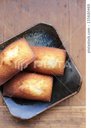 Freshly baked, crispy and fluffy financiers served on a Japanese plate Freshly baked, crispy and fluffy financiers served on a Japanese plate 135680469