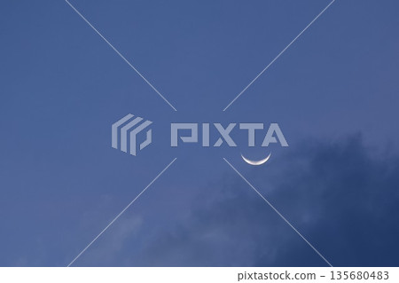 half moon floating on dark blue sky in twilight background half moon floating on dark blue sky in twilight background 135680483