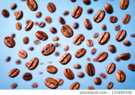 Roasted Coffee Beans Floating in Air on Blue Background Roasted Coffee Beans Floating in Air on Blue Background 135680506