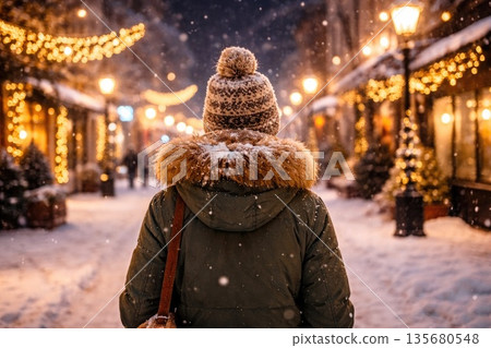 Winter Evening Walk in Festive European Street with Snowfall 135680548