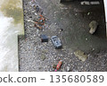 Garbage dumped on the riverbank 135680589