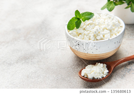 Cottage cheese in bowl with mint leaves Cottage cheese in bowl with mint leaves 135680613