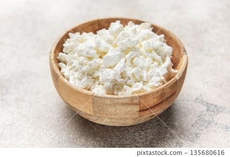 Cottage cheese in wooden bowl for healthy breakfast 135680616