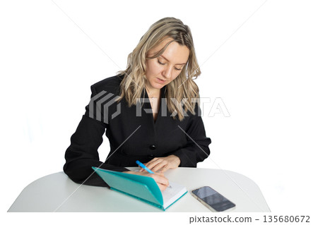 Business Woman Writing in Diary During Office Hours in Modern Workspace Business Woman Writing in Diary During Office Hours in Modern Workspace 135680672