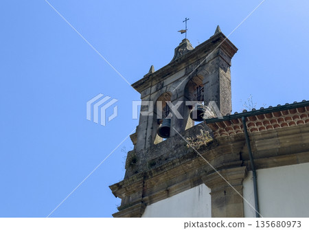 Old European belfry tower with stone architecture and clock, symbolizing history, religion and 135680973