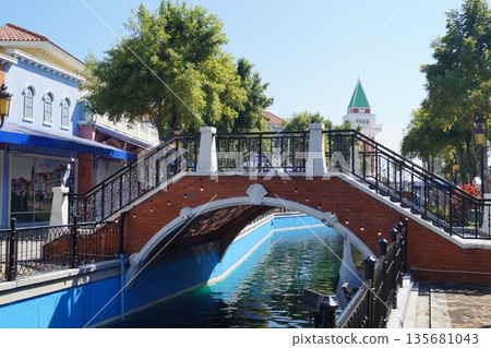 Little Venice in Thailand.Streets and canals of old Venice in Thailand with wooden gondolas, stone bridges, and a blue sky in the background. Little Venice in Thailand.Streets and canals of old Venice in Thailand with wooden gondolas, stone bridges, and a blue sky in the background. 135681043