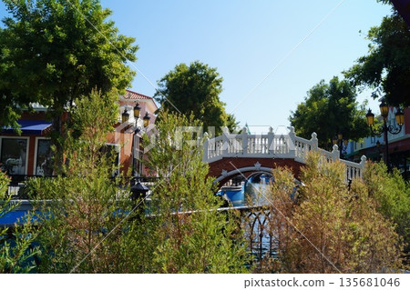 Streets and canals of old Venice in Thailand with wooden gondolas, stone bridges, and a sky in the background. Streets and canals of old Venice in Thailand with wooden gondolas, stone bridges, and a sky in the background. 135681046