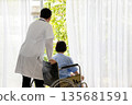 Doctor standing behind an elderly woman in a wheelchair, both looking out the window. The scene captures a calm, caring moment, symbolizing hope, recovery, and compassionate elderly care 135681591