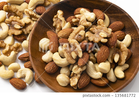 Mixed nuts in a wooden bowl 135681772