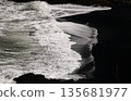 Waves crashing on a black sand beach 135681977