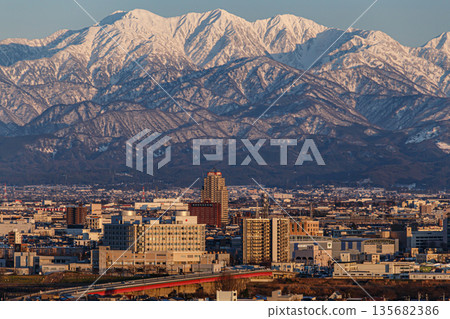 The cityscape with the Tateyama mountain range in the background 135682386
