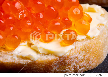 Sandwich with red caviar. Red ikura. Macro shot. 135682690