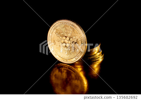Cardano coins on black background. Cryptocurrency concept. Cardano coins on black background. Cryptocurrency concept. 135682692