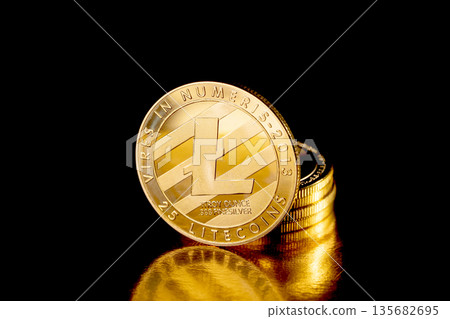 Litecoin cryptocurrency. Gold coins on black background. 135682695