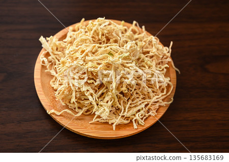 Dried daikon radish served on a wooden plate 135683169