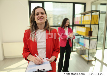 Bright office scene showcases teamwork and creativity during a productive work session in a modern workspace 135683359