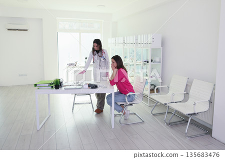 Health consultation in a modern clinic with a doctor explaining to a patient about her condition Health consultation in a modern clinic with a doctor explaining to a patient about her condition 135683476