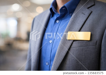 Professional Businessman Wearing Suit with Blank Name Badge for Corporate Identity Concept Professional Businessman Wearing Suit with Blank Name Badge for Corporate Identity Concept 135683575