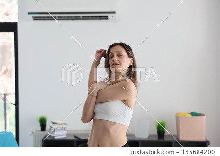 Woman practicing mindfulness and stretching at home in a calm and serene living space Woman practicing mindfulness and stretching at home in a calm and serene living space 135684200