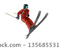 Skier in flight. Jump. Sportsman in a red ski suit. Skiing in action. Side view. High speed. Isolated 135685531