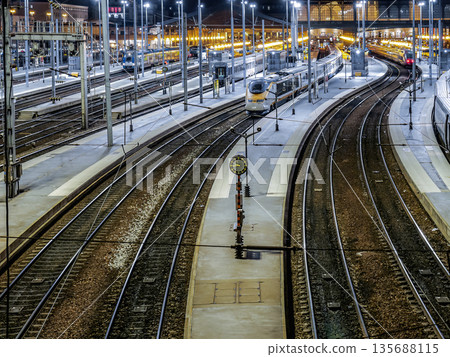 Night Train Station With Multiple Tracks And Trains At Platform Dusk To Night Night Train Station With Multiple Tracks And Trains At Platform Dusk To Night 135688115