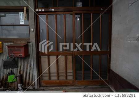 The entrance of a Showa-era mortar house, with a frosted glass sliding door 135688291