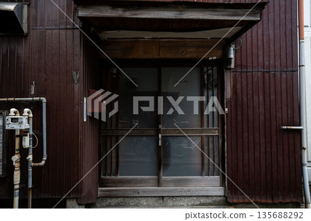The entrance of a Showa-era mortar house, with a frosted glass sliding door The entrance of a Showa-era mortar house, with a frosted glass sliding door 135688292