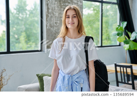 Portrait of student girl, positive smiling beautiful blonde with backpack looking at camera 135689594