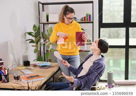 Creative brainstorming session in a bright modern workspace with colorful papers and engaging ideas Creative brainstorming session in a bright modern workspace with colorful papers and engaging ideas 135690039