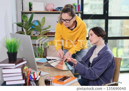 Collaborating on a vibrant design project in a modern workspace during daylight hours Collaborating on a vibrant design project in a modern workspace during daylight hours 135690040
