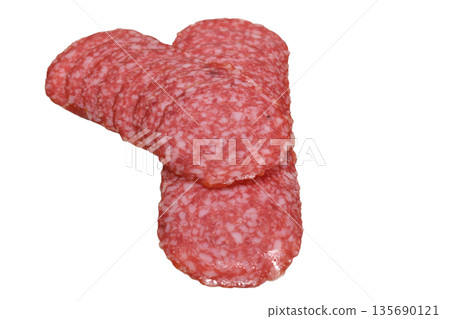 Dry-cured sausage is cut into thin slices. 135690121
