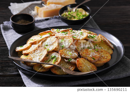 Roasted Potato Slices with Parmesan Cheese Top View 135690211
