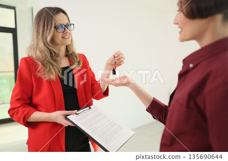 New beginning as keys are handed over in a bright room showcasing excitement and hope 135690644