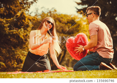 Playful couple in park. 135690746