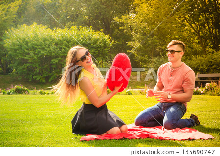 Couple with big heart on picnic Couple with big heart on picnic 135690747