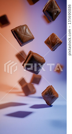 Floating chocolate cubes, neon color background, Valentine's Day material 135690886