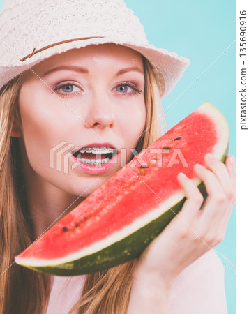 Happy woman holding watermelon Happy woman holding watermelon 135690916
