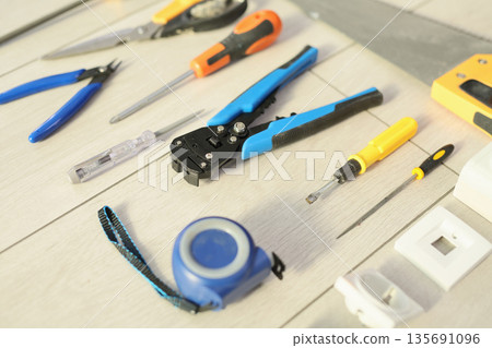 Workstation filled with various hand tools for DIY projects and crafts in a bright workspace during the day Workstation filled with various hand tools for DIY projects and crafts in a bright workspace during the day 135691096