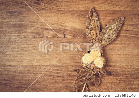 Easter bunny made of straw, on a wooden background, top view, no people, Easter bunny made of straw, on a wooden background, top view, no people, 135691146