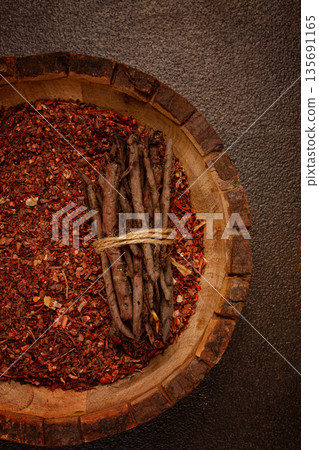 Madder dye, Endro, rhizome for coloring eggs, powder from the roots of endro with onion husks, in a wooden plate, top view, Easter, Georgia, 135691165