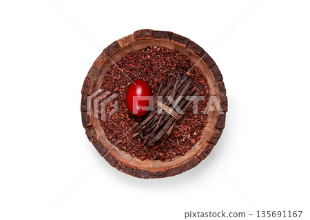 Madder dye, Endro, rhizome for coloring eggs, powder from the roots of endro with onion husks, in a wooden plate, top view, Easter, Georgia, Madder dye, Endro, rhizome for coloring eggs, powder from the roots of endro with onion husks, in a wooden plate, top view, Easter, Georgia, 135691167