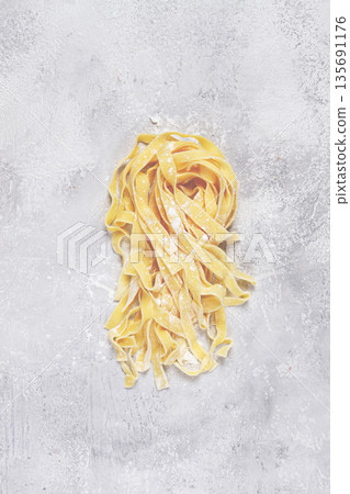 raw tagliatelli pasta , homemade, top view, no people, rustic, food concept, 135691176