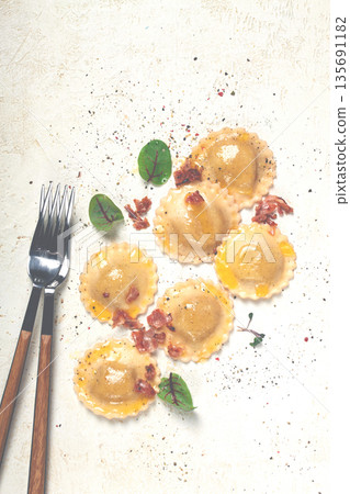 fresh ravioli, with butter, spices and herbs, fried bacon, on the table, top view, light background, no people, fresh ravioli, with butter, spices and herbs, fried bacon, on the table, top view, light background, no people, 135691182