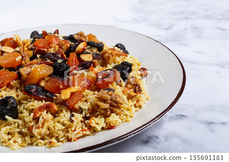 rice dish with dried fruits, nuts and spices of Middle Eastern cuisine, homemade, no people, 135691183