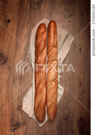 fresh French baguette, two pieces, top view, on the table, no people, fresh French baguette, two pieces, top view, on the table, no people, 135691184
