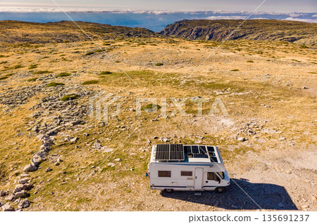 Caravan solar panels on roof camp in mountains. Aerial view 135691237